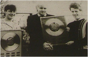 Caption: DIDN&rsquo;T THEY DO WELL&hellip;Lloyd Barnett (left) and Mark Mortimer receive their Musicbox poll trophies from the column&rsquo;s editor Sam Holliday (centre).